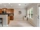 Kitchen dining area with wooden cabinets, granite countertops, stainless appliances and wood-look flooring at 690 Cobblestone Creek Ln, Mableton, GA 30126