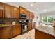 Modern kitchen featuring stainless steel appliances, granite countertops and updated cabinetry at 690 Cobblestone Creek Ln, Mableton, GA 30126