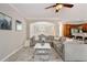 Living room with fireplace, flat screen tv, large sectional sofa and adjacent kitchen with granite counters and stainless appliances at 690 Cobblestone Creek Ln, Mableton, GA 30126