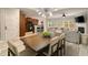 Open concept living room and kitchen featuring modern lighting, a fireplace, and a large dining table at 690 Cobblestone Creek Ln, Mableton, GA 30126