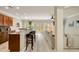 Open living space with a breakfast bar, modern seating, wood floors, and seamless flow between kitchen and living room at 690 Cobblestone Creek Ln, Mableton, GA 30126