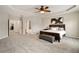 Spacious main bedroom featuring a tray ceiling, ceiling fan, and ensuite bath at 690 Cobblestone Creek Ln, Mableton, GA 30126