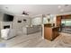 Open floor plan with kitchen island and stainless appliances leading into the living area at 690 Cobblestone Creek Ln, Mableton, GA 30126