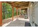 Covered patio offers scenic views of the lush trees and landscape, perfect for outdoor relaxation at 690 Cobblestone Creek Ln, Mableton, GA 30126