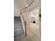 Open staircase with carpeted steps, a wood railing, and a view into the adjacent living area and entry at 690 Cobblestone Creek Ln, Mableton, GA 30126