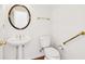 Elegant powder room with pedestal sink, classic fixtures, and hardwood floors at 1545 Center Cross Pass, Marietta, GA 30062
