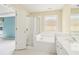 Bright bathroom with tiled floors and a shower and soaking tub combo under a window at 1545 Center Cross Pass, Marietta, GA 30062