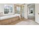 Bathroom with tub, glass shower, stained-glass window, and view into the Primary bedroom at 1545 Center Cross Pass, Marietta, GA 30062