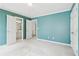 An open bedroom features blue walls, carpet floors, and several doors for easy access at 1545 Center Cross Pass, Marietta, GA 30062