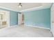 Open bedroom showcases neutral carpet, blue walls, white trim, and elegant ceiling light fixture at 1545 Center Cross Pass, Marietta, GA 30062