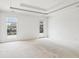 Bedroom features a tray ceiling, carpeted floor, and natural light from the backyard at 1545 Center Cross Pass, Marietta, GA 30062