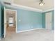 A bright bedroom has an open doorway, neutral carpet, and a tray ceiling with a light fixture at 1545 Center Cross Pass, Marietta, GA 30062