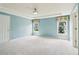 Spacious bedroom with soft blue walls, carpet floors, tray ceiling, and natural light from two windows at 1545 Center Cross Pass, Marietta, GA 30062