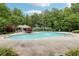 Inviting community pool with ample seating, lush landscaping, and a pergola-covered area for relaxing at 1545 Center Cross Pass, Marietta, GA 30062