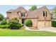 Charming brick home with a well-manicured lawn and a two-car garage, offering classic curb appeal at 1545 Center Cross Pass, Marietta, GA 30062