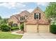 Charming brick home with a well-manicured lawn, two-car garage, and traditional architectural details at 1545 Center Cross Pass, Marietta, GA 30062