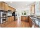Well-equipped kitchen with stainless steel appliances, granite countertops, and warm wood cabinets at 1545 Center Cross Pass, Marietta, GA 30062