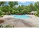 Community pool with lounge chairs and a bath house surrounded by lush trees at 1545 Center Cross Pass, Marietta, GA 30062