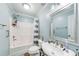 Cozy bathroom with shower-tub combo, grey vanity, and decorative mirror at 1720 Alcovy River Dr, Dacula, GA 30019