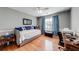 Cozy bedroom featuring hardwood floors, blue accents, and a comfortable daybed at 1720 Alcovy River Dr, Dacula, GA 30019