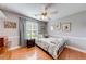 Bedroom with hardwood floors, a ceiling fan, and plenty of natural light at 1720 Alcovy River Dr, Dacula, GA 30019
