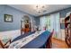 Cozy dining room featuring blue walls, hardwood floors, and natural light at 1720 Alcovy River Dr, Dacula, GA 30019