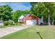 Charming brick and siding home with a well-manicured lawn and mature trees at 1720 Alcovy River Dr, Dacula, GA 30019