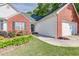 Close up of the exterior of the home featuring brick accents and a manicured front yard at 1720 Alcovy River Dr, Dacula, GA 30019