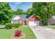 Charming single-story brick home featuring a well-manicured front yard and attached garage at 1720 Alcovy River Dr, Dacula, GA 30019