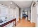 Hallway featuring arched doorways, hardwood floors, and decorative wainscoting at 1720 Alcovy River Dr, Dacula, GA 30019