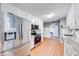 Modern kitchen featuring stainless steel appliances, granite countertops, and hardwood floors at 1720 Alcovy River Dr, Dacula, GA 30019