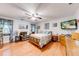 Spacious main bedroom with hardwood floors, a ceiling fan, and comfortable seating at 1720 Alcovy River Dr, Dacula, GA 30019