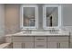 Modern bathroom featuring dual sinks, illuminated mirrors, marble countertop, tile backsplash and flooring at 194 Jennifer Nw Ln, Lilburn, GA 30047