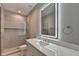 Modern bathroom featuring an illuminated mirror, glass shower, and white vanity at 194 Jennifer Nw Ln, Lilburn, GA 30047