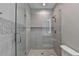 Modern bathroom featuring a glass-enclosed shower with gray tiling and a rainfall showerhead at 194 Jennifer Nw Ln, Lilburn, GA 30047