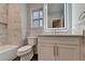 Well-lit bathroom featuring marble tiling, modern vanity and hardware, and tiled backsplash at 194 Jennifer Nw Ln, Lilburn, GA 30047
