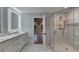 Bathroom featuring dual sinks, marble countertop, tile backsplash, glass enclosed shower, marble tile flooring at 194 Jennifer Nw Ln, Lilburn, GA 30047