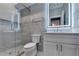 Modern bathroom featuring a glass-enclosed shower, gray tiling, and a lighted vanity mirror at 194 Jennifer Nw Ln, Lilburn, GA 30047