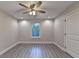Bedroom with neutral walls, wood-look flooring, ceiling fan, and white trim at 194 Jennifer Nw Ln, Lilburn, GA 30047