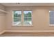 Bedroom view featuring base molding and three windows looking out onto the landscaped yard at 194 Jennifer Nw Ln, Lilburn, GA 30047