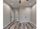 Bedroom featuring wood-look flooring, neutral walls, ceiling fan, and double closet doors at 194 Jennifer Nw Ln, Lilburn, GA 30047