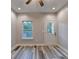 Bedroom features wood-look floors, neutral walls, and a ceiling fan with integrated light fixture at 194 Jennifer Nw Ln, Lilburn, GA 30047