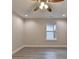 A bright room with a fan, vinyl floors, and a single window at 194 Jennifer Nw Ln, Lilburn, GA 30047