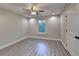 Bedroom with neutral walls, wood-look flooring, ceiling fan, and white trim at 194 Jennifer Nw Ln, Lilburn, GA 30047