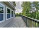 Wooden deck with railing along the side of the house overlooking greenery at 194 Jennifer Nw Ln, Lilburn, GA 30047