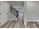 Foyer with hardwood floors, staircase with wrought iron railing, and a front door at 194 Jennifer Nw Ln, Lilburn, GA 30047