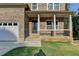 The beautiful covered front porch and attractive front door are very welcoming at 194 Jennifer Nw Ln, Lilburn, GA 30047
