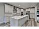 Modern kitchen featuring white cabinets, stainless steel appliances, and a large marble-topped island at 194 Jennifer Nw Ln, Lilburn, GA 30047