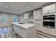 Modern kitchen with white cabinets, marble countertops, and a large island at 194 Jennifer Nw Ln, Lilburn, GA 30047