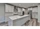 Modern kitchen featuring white cabinets, stainless steel appliances, and a large marble-topped island at 194 Jennifer Nw Ln, Lilburn, GA 30047